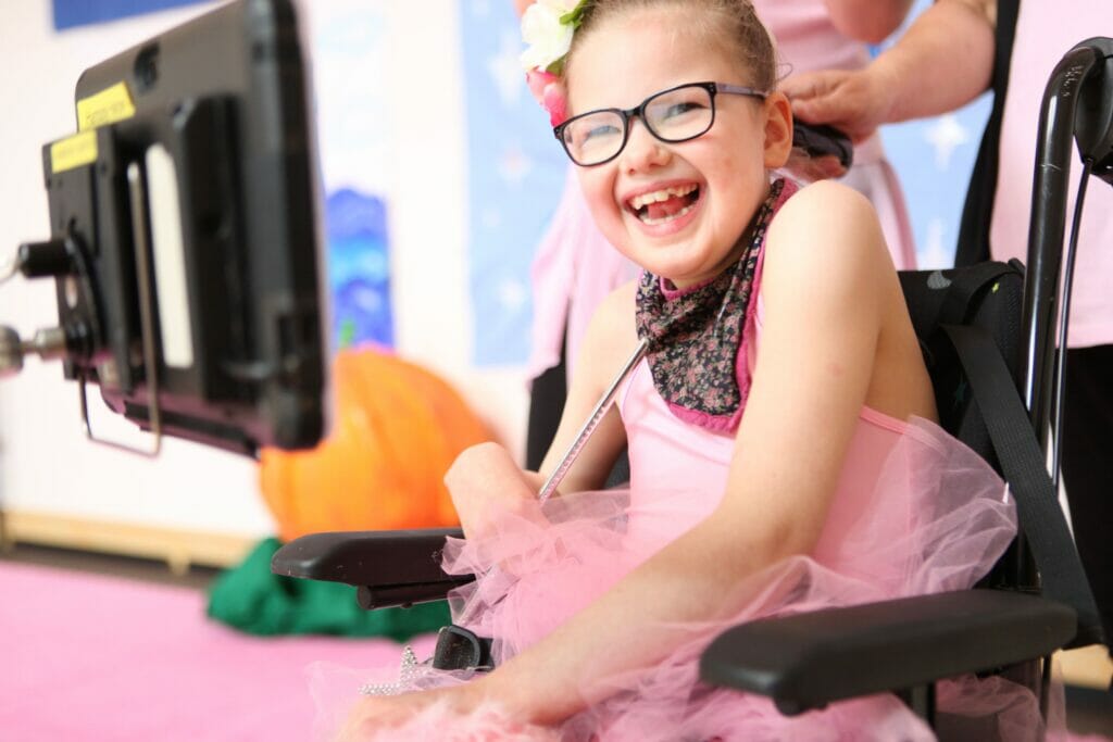 One of our flamingo chicks dancers smiles from her wheelchair